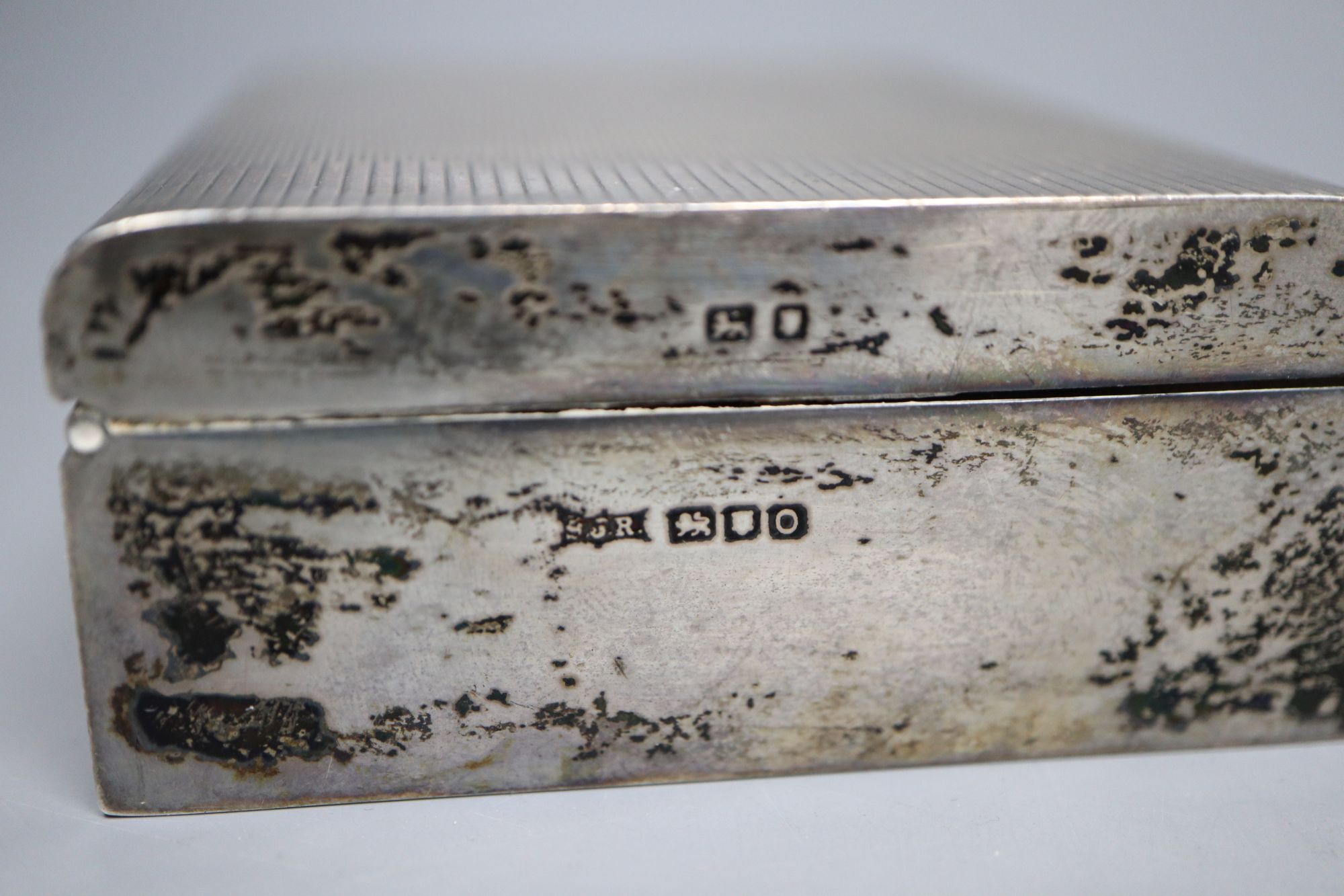 A small Edwardian silver cigarette box, 87mm and a small silver ashtray.